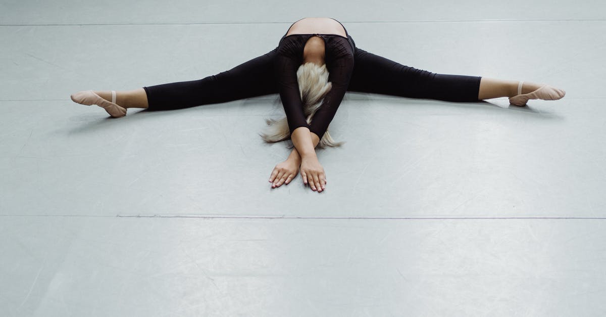 How to get from Split to Stanici? - From above full body of anonymous ballerina practicing twine position on floor in choreography hall How to get from Split to Stanici? - From above full body of anonymous ballerina practicing twine position on floor in choreography hall