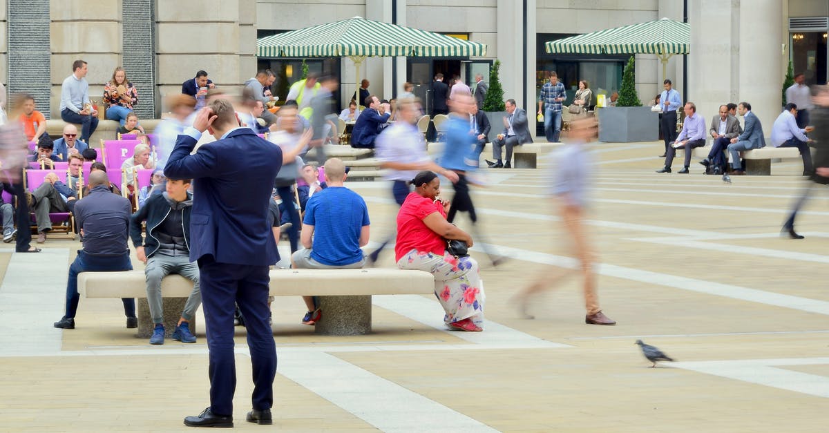 How to get off a London bus when sitting on the top deck? - Man Wearing Blue Suit on Beige Ground Near Building