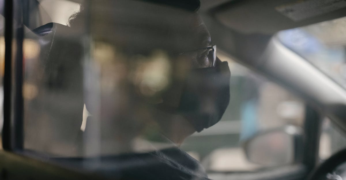 How to get safe through Mauritania - Through glass of crop concentrated ethnic man in eyeglasses sitting in car and wearing medical mask because of coronavirus pandemic How to get safe through Mauritania - Through glass of crop concentrated ethnic man in eyeglasses sitting in car and wearing medical mask because of coronavirus pandemic