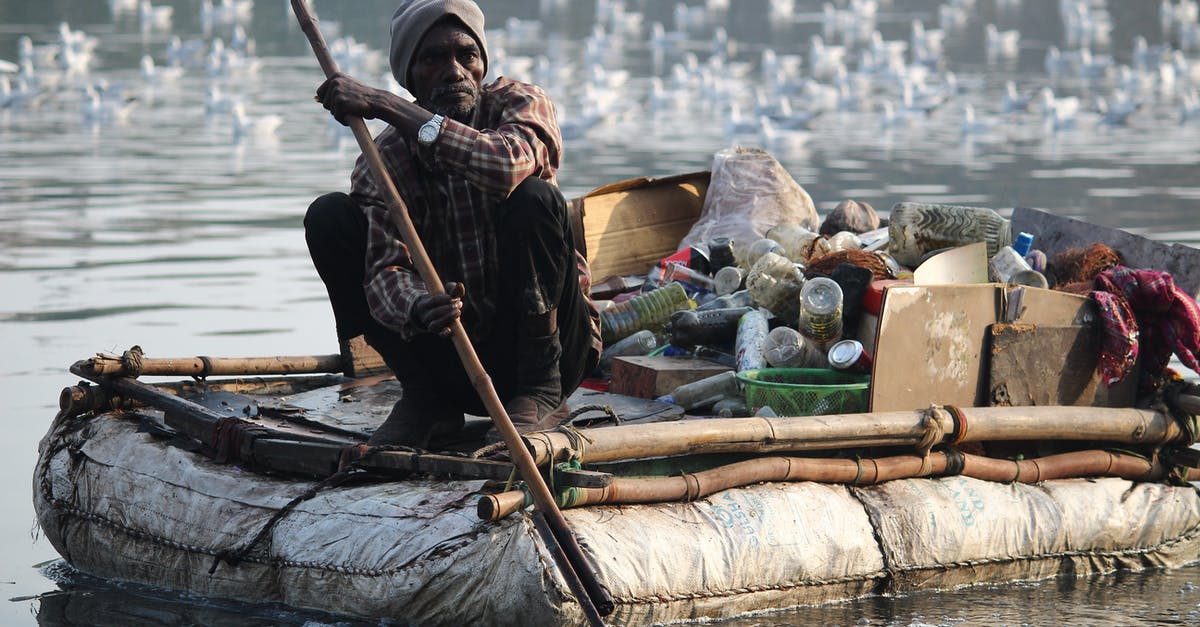 How to go boating in the Ganges? - Man Sitting on Boat How to go boating in the Ganges? - Man Sitting on Boat