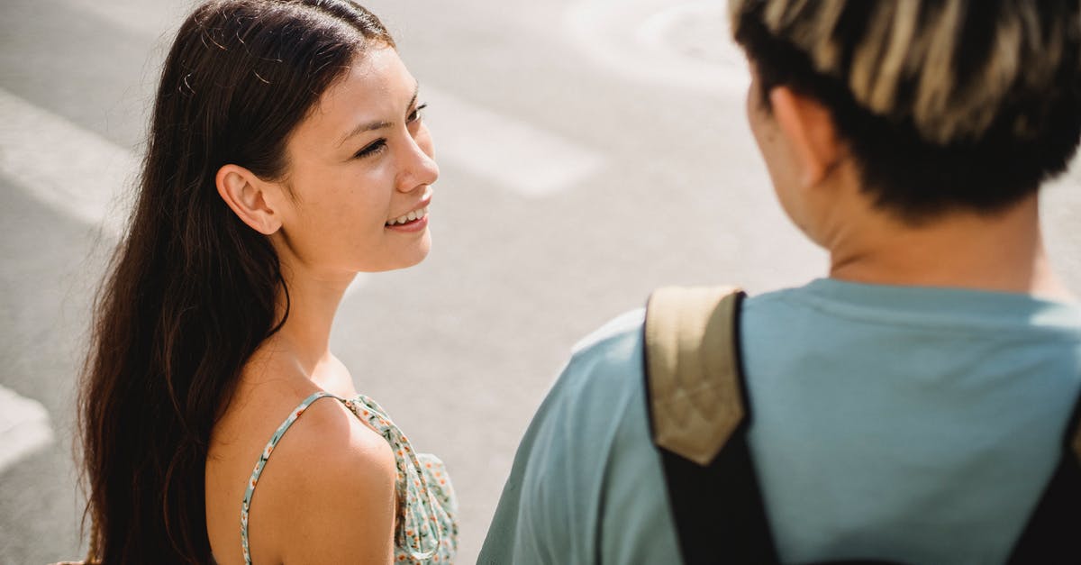 How to go from all four Moscow's (DME-SVO-VKO-ZIA) international airports to the city center? [closed] - Smiling young girlfriend standing on crosswalk with boyfriend