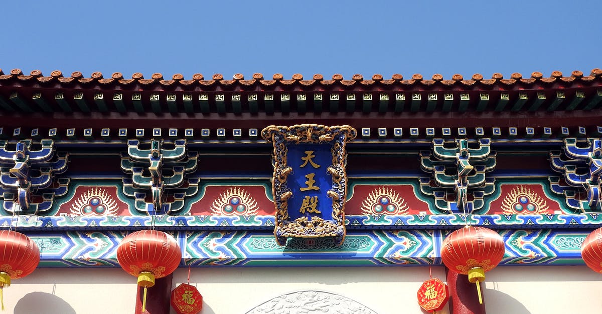 How to go from Vladivostok to Beijing by land? - From below of colorful Beijing Dongyue Temple located in Beijing in China decorated with red lanterns and ornaments with hieroglyphs and decorative elements in sunny day under blue cloudless sky How to go from Vladivostok to Beijing by land? - From below of colorful Beijing Dongyue Temple located in Beijing in China decorated with red lanterns and ornaments with hieroglyphs and decorative elements in sunny day under blue cloudless sky