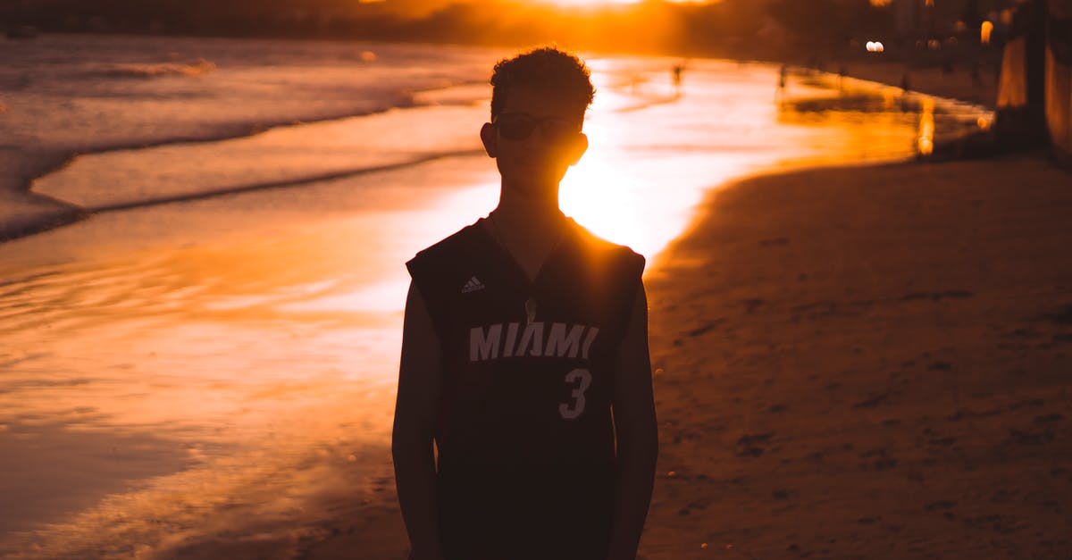 How to handle a 12 hour layover in Miami - Man in Black vest Standing on Beach during Sunset How to handle a 12 hour layover in Miami - Man in Black vest Standing on Beach during Sunset