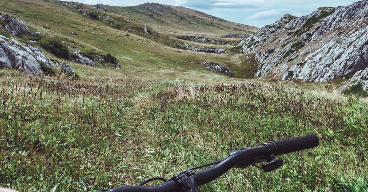 How to handle payments while travelling to Indonesia? - Person Riding Bicycle Overlooking Green Grass Field and Hill How to handle payments while travelling to Indonesia? - Person Riding Bicycle Overlooking Green Grass Field and Hill