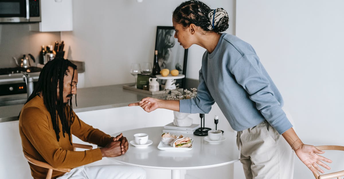 How to interpret the relationship status question in a UK visa application? - African American couple having conflict at kitchen