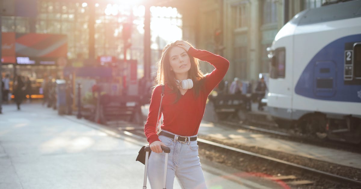How to keep track of all things you are carrying in the luggage and where they are? - Serious woman posing at railroad station