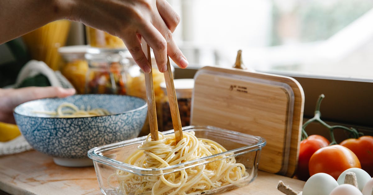 How to know if a meal was cooked with or contains alcohol? - Unrecognizable female cook with tongs standing at counter with glass container of fresh pasta while cooking in kitchen on blurred background How to know if a meal was cooked with or contains alcohol? - Unrecognizable female cook with tongs standing at counter with glass container of fresh pasta while cooking in kitchen on blurred background