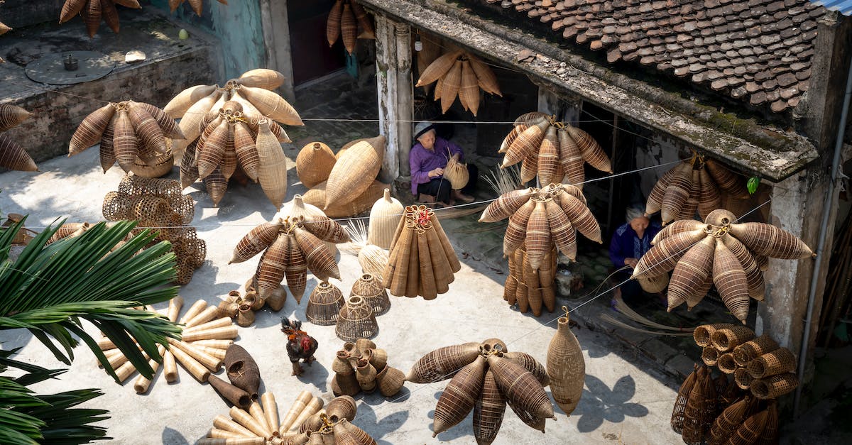 How to make ear plugs work in the tropics - From above of people sitting and making bamboo fish traps while working on local bazaar in Vietnam in daylight How to make ear plugs work in the tropics - From above of people sitting and making bamboo fish traps while working on local bazaar in Vietnam in daylight