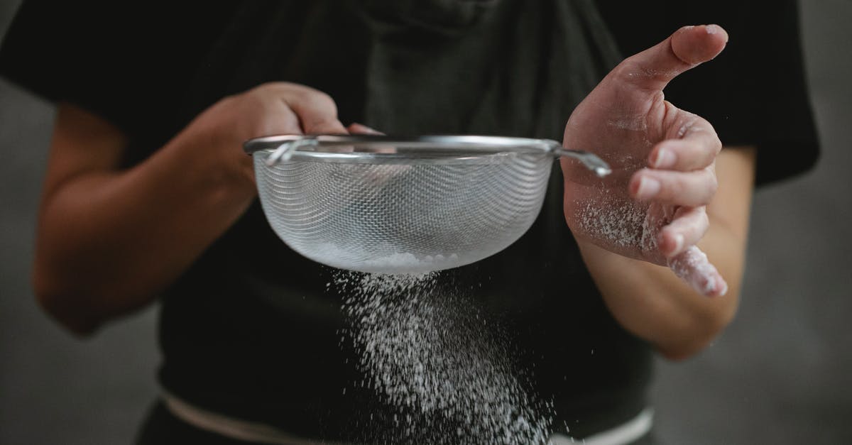 How to make ear plugs work in the tropics - Crop anonymous cook in apron sifting flour while preparing baking dish against gray background How to make ear plugs work in the tropics - Crop anonymous cook in apron sifting flour while preparing baking dish against gray background