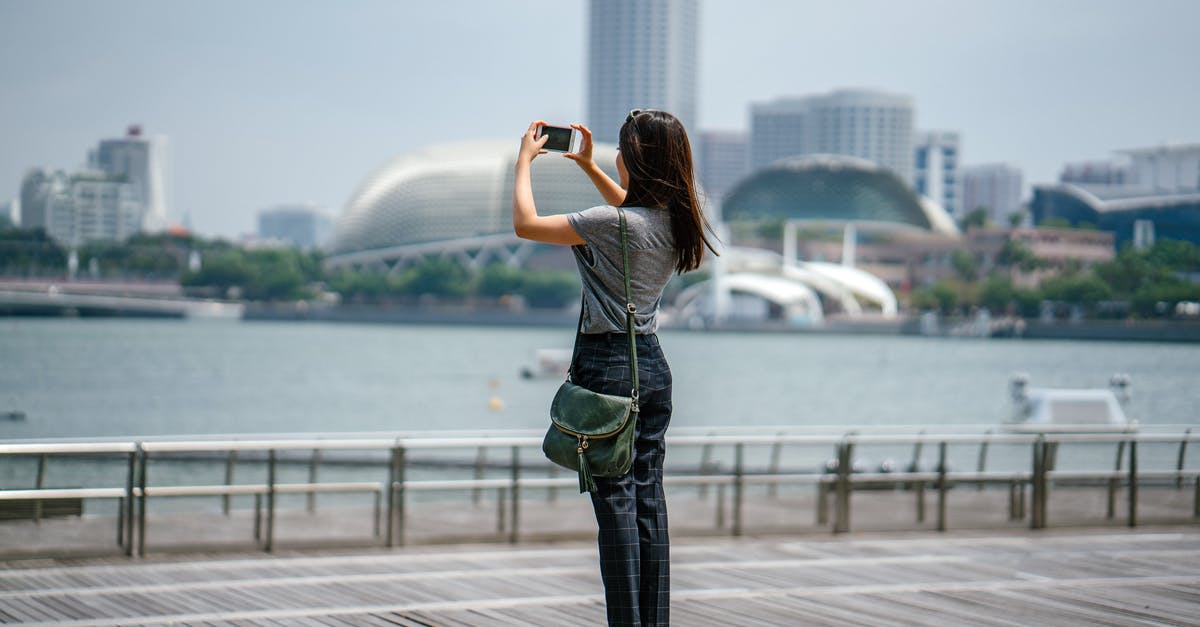 How to obtain a 60-day Indonesian tourist visa in Singapore? - Woman Standing Taking Picture of Scenery How to obtain a 60-day Indonesian tourist visa in Singapore? - Woman Standing Taking Picture of Scenery
