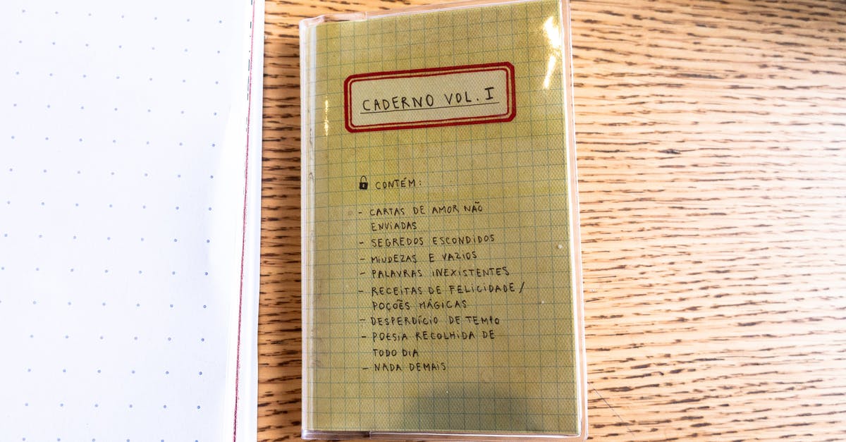 How to organize the documents and write a cover letter for UK Visa? - Top view squared copybook with handwritten inscriptions in Spanish on cover placed on table in daylight