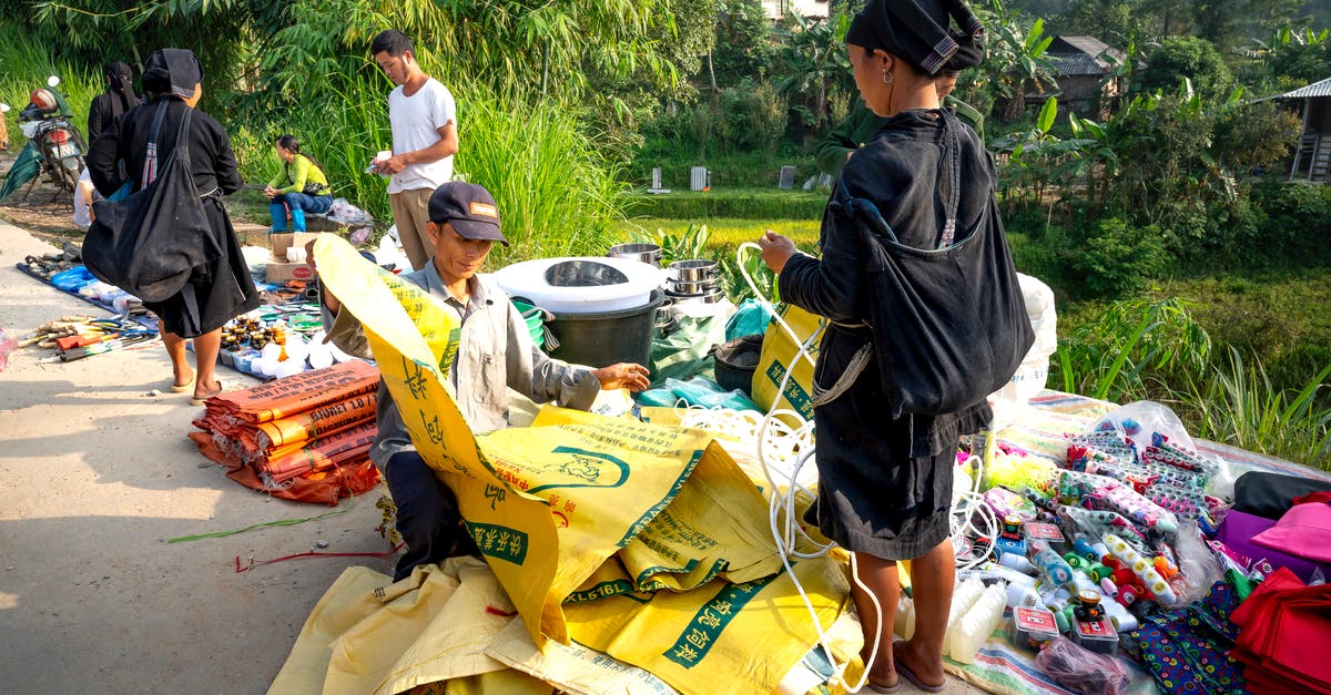 How to politely ask people from East Asia to give way? [closed] - Asian people standing near indigenous market with goods on ground