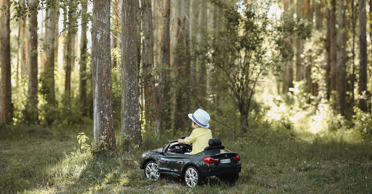 How to prepare for driving on the opposite side for the first time, after decades driving on the other side [duplicate] - Little Boy in Hat Driving Toy Car in Forest