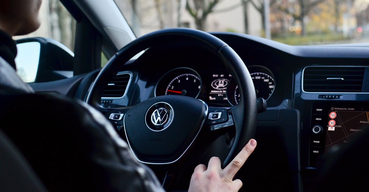 How to prepare for driving on the opposite side for the first time, after decades driving on the other side [duplicate] - Back view of crop anonymous male driving contemporary transport while turning steering wheel in daylight