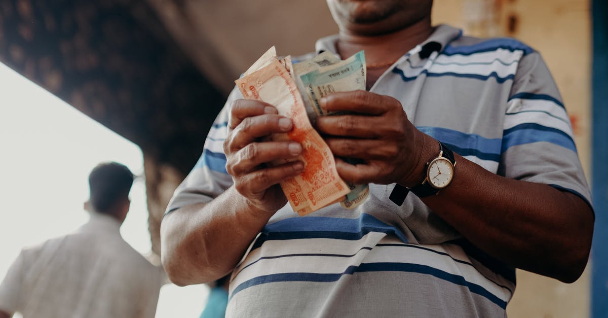 How to reach Goa from Delhi without any money - Man in Blue and White Stripe Polo Shirt Holding Banknote How to reach Goa from Delhi without any money - Man in Blue and White Stripe Polo Shirt Holding Banknote
