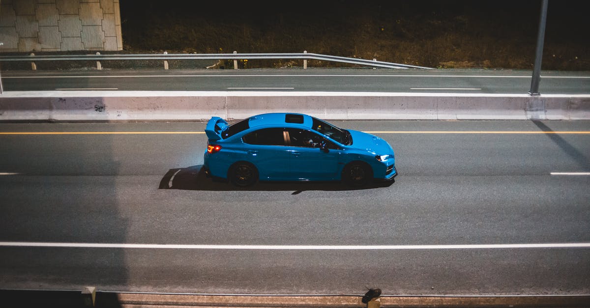 How to reach Reykjavík-Keflavík airport late in the evening from the Blue Lagoon? - Blue car driving on road in late evening