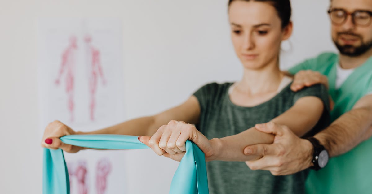 How to reach Treriksröset? - Crop orthopedist checking up female patient with elastic band How to reach Treriksröset? - Crop orthopedist checking up female patient with elastic band