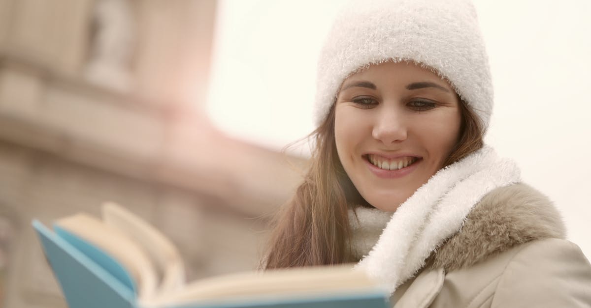 How to read female clothing labels in Poland? [closed] - A Happy Woman in White Knitted Beanie Reading a Book