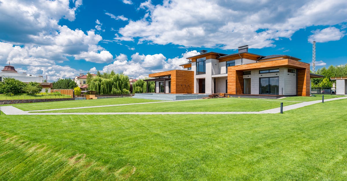 How to re-apply after refusals for both settlement and visitor visas? [duplicate] - Exterior of modern residential house with wooden walls and green grass growing in yard against blue sky with white clouds