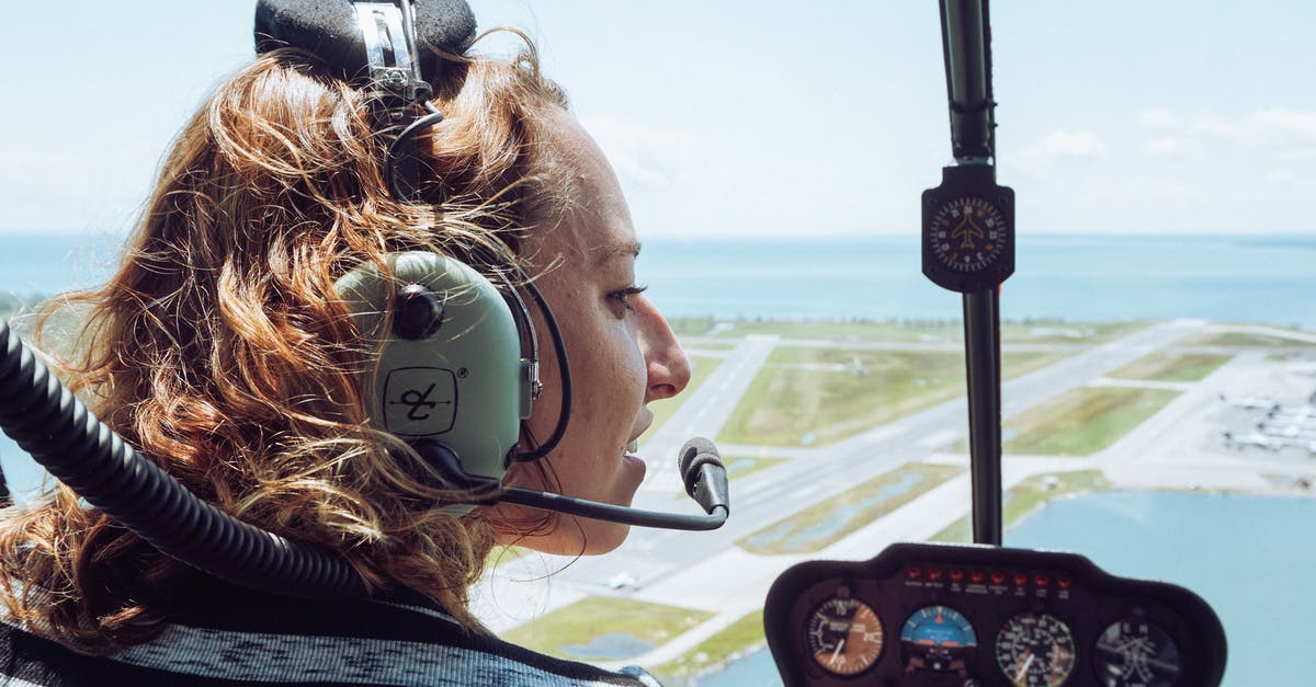 How to recognise/thank great cabin crew? - Back view of positive young female traveler in casual wear and headset sitting in cockpit of modern helicopter during flight over coastal town How to recognise/thank great cabin crew? - Back view of positive young female traveler in casual wear and headset sitting in cockpit of modern helicopter during flight over coastal town