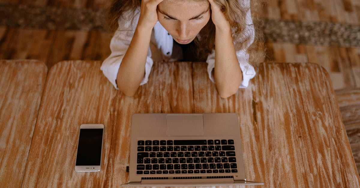 How to reduce anxiety about travelling using airplanes? [duplicate] - High Angle Photo of Woman Looking Upset in Front of Silver Laptop