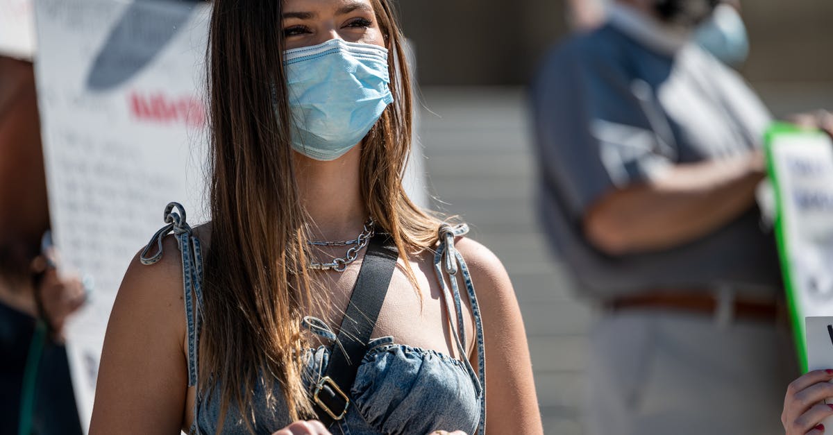 How to safely turn right in Thailand - Young woman in mask protesting on street How to safely turn right in Thailand - Young woman in mask protesting on street