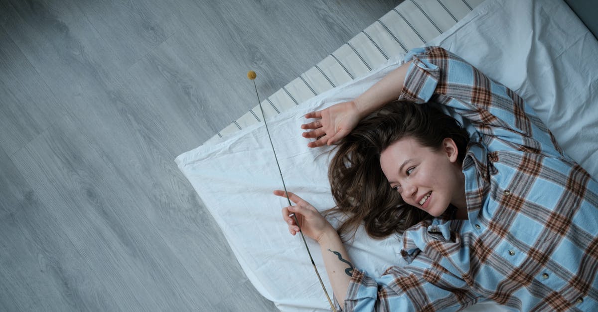 How to sleep on an overnight layover in Kotoka Airport, Accra - Girl Lying on Blue and White Plaid Blanket How to sleep on an overnight layover in Kotoka Airport, Accra - Girl Lying on Blue and White Plaid Blanket