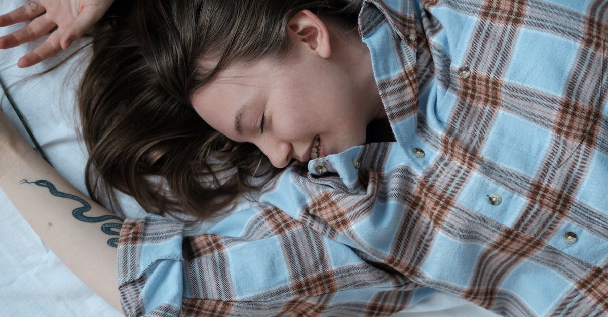 How to sleep on an overnight layover in Kotoka Airport, Accra - Girl in Blue White and Red Plaid Dress Shirt Lying on Bed How to sleep on an overnight layover in Kotoka Airport, Accra - Girl in Blue White and Red Plaid Dress Shirt Lying on Bed