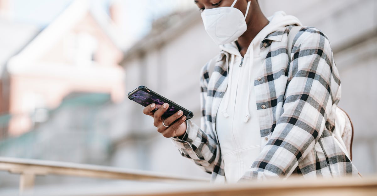 How to stay safe when using an autocaravan? - Black woman using smartphone on city street How to stay safe when using an autocaravan? - Black woman using smartphone on city street