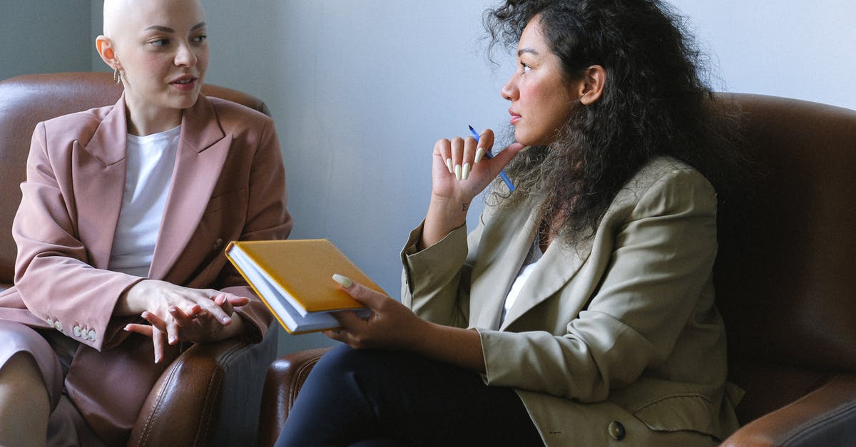 How to tell if an apartment listing is legit and booking is valid? - Young female friends having conversation sitting in armchairs in room How to tell if an apartment listing is legit and booking is valid? - Young female friends having conversation sitting in armchairs in room