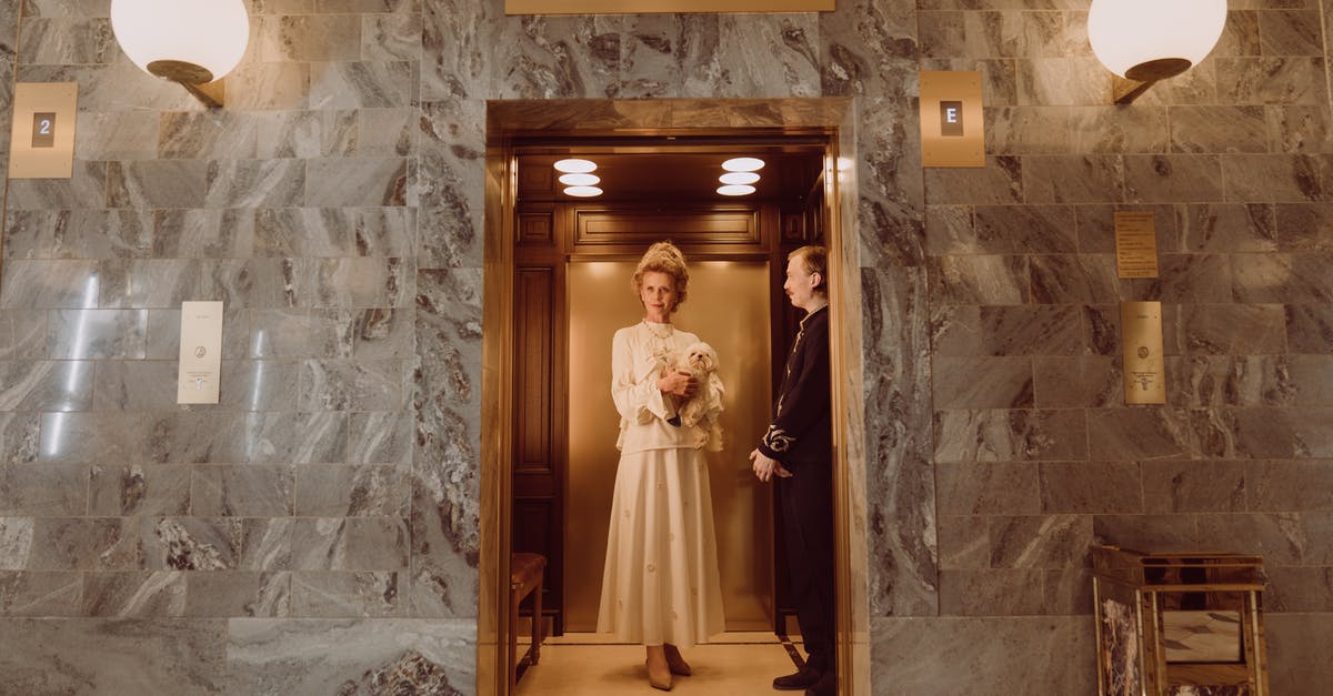How to tip a concierge or a hotel porter? - Woman in White Dress Standing on Brown Wooden Door How to tip a concierge or a hotel porter? - Woman in White Dress Standing on Brown Wooden Door