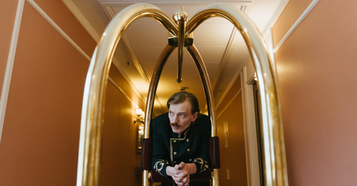How to tip a concierge or a hotel porter? - Woman in Black Long Sleeve Shirt Sitting on Brown Wooden Chair How to tip a concierge or a hotel porter? - Woman in Black Long Sleeve Shirt Sitting on Brown Wooden Chair