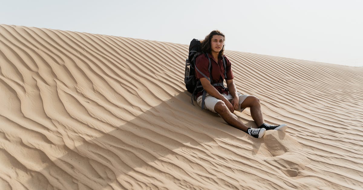 How to travel if you are stateless? - Woman in Black Shirt Sitting on Brown Sand How to travel if you are stateless? - Woman in Black Shirt Sitting on Brown Sand