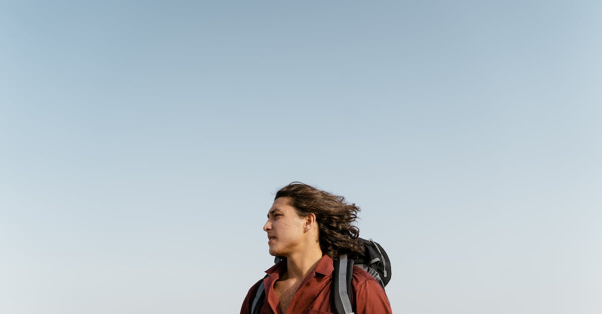 How to travel if you are stateless? - Man in Red Jacket Standing Under White Sky How to travel if you are stateless? - Man in Red Jacket Standing Under White Sky