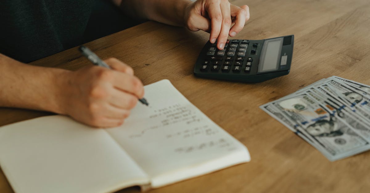 How to unlock WeChat money as a foreigner in China? [closed] - Person Writing on White Paper Beside Black Desk Calculator