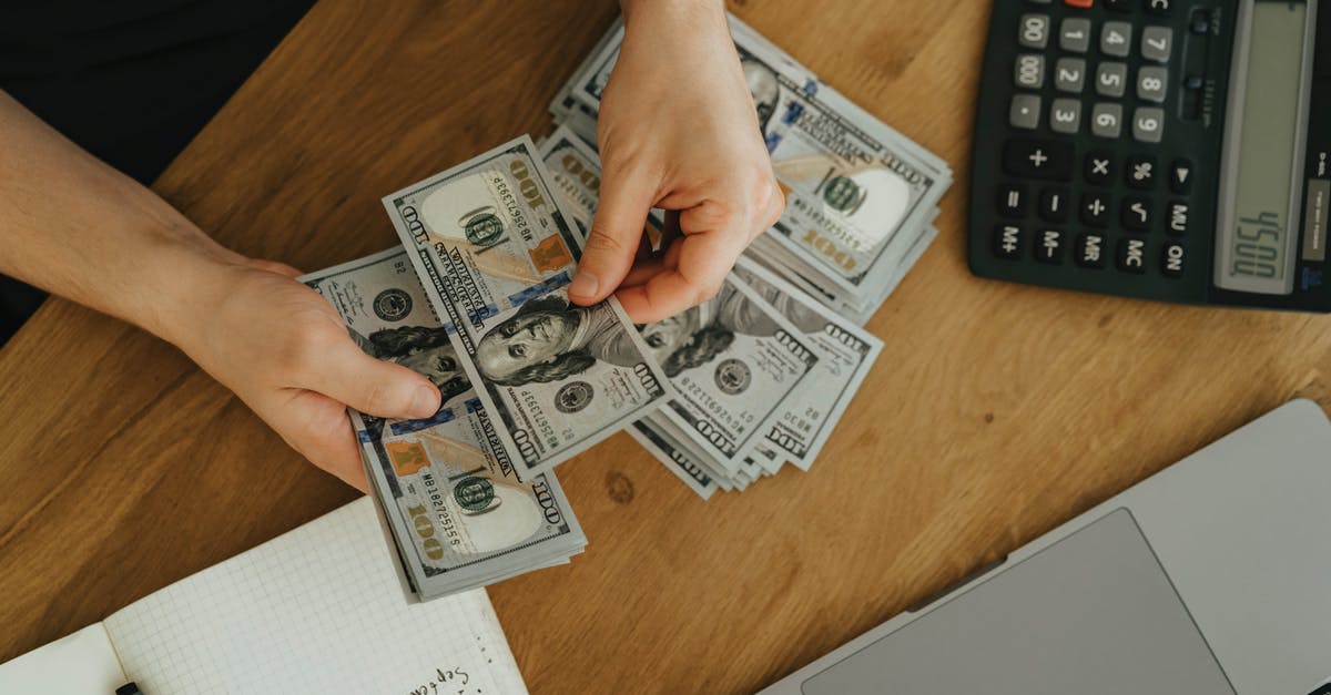 How to unlock WeChat money as a foreigner in China? [closed] - Person Holding Fan of Us Dollar Bill