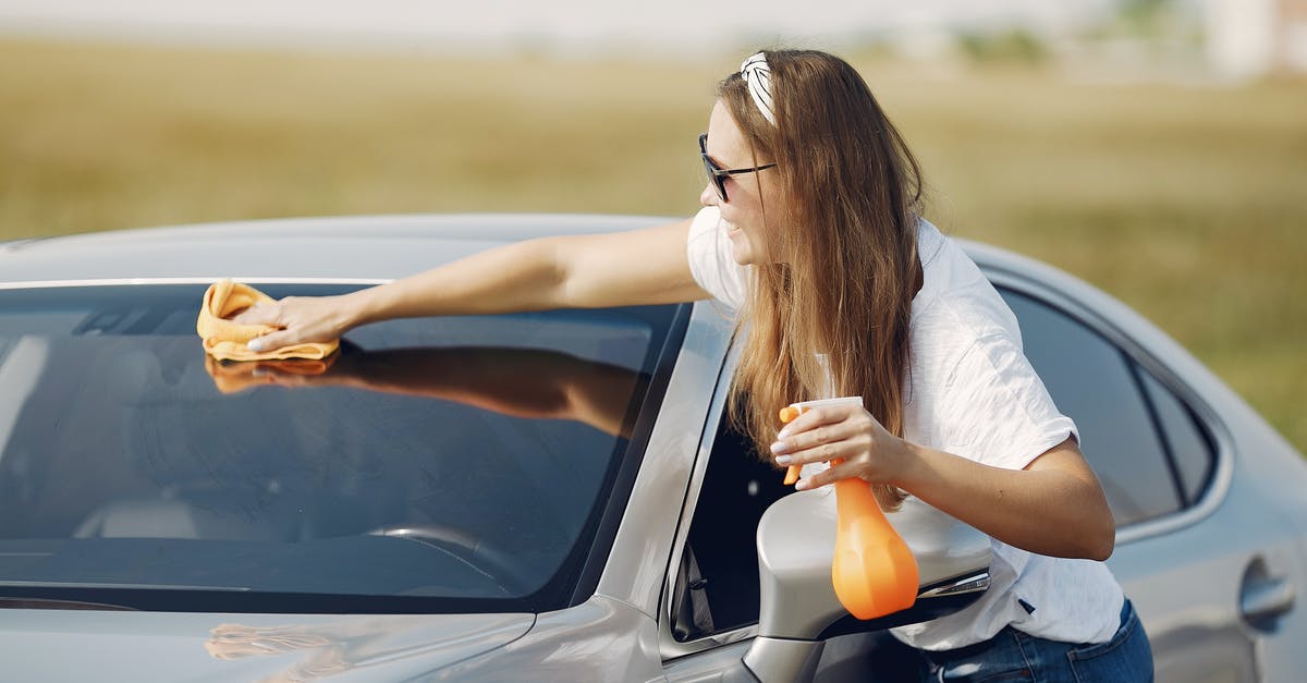 How to use hotmail / email for use on holiday abroad - Side view of cheerful female driver in sunglasses and casual clothes cleaning windshield of modern car with microfiber cloth and spray bottle against green field How to use hotmail / email for use on holiday abroad - Side view of cheerful female driver in sunglasses and casual clothes cleaning windshield of modern car with microfiber cloth and spray bottle against green field