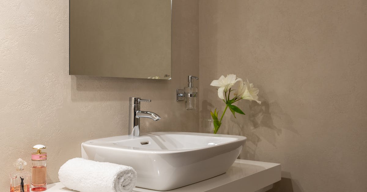 How to use Turkish toilet tap? - Interior of bathroom with white wrapped towel near ceramic basin and faucet with mirror on wall How to use Turkish toilet tap? - Interior of bathroom with white wrapped towel near ceramic basin and faucet with mirror on wall