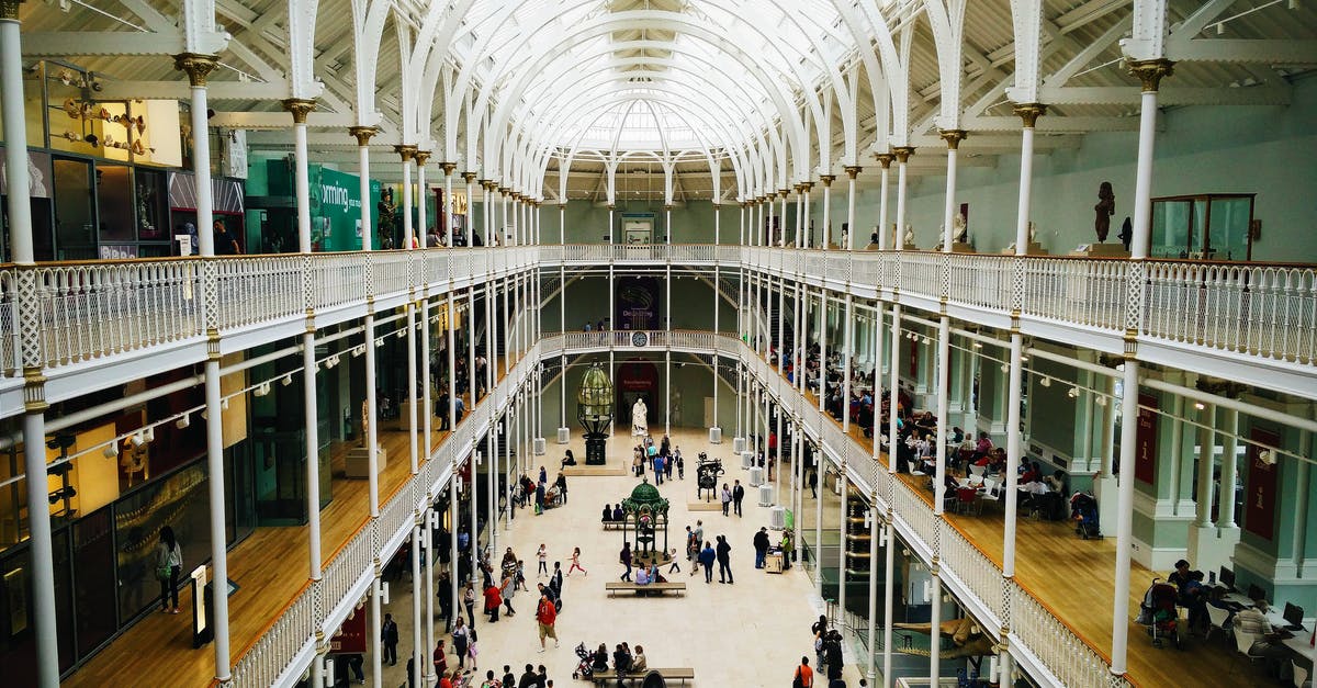 How to visit Edinburgh during a layover at Edinburgh Airport? - People Walking on Hallway Inside Building