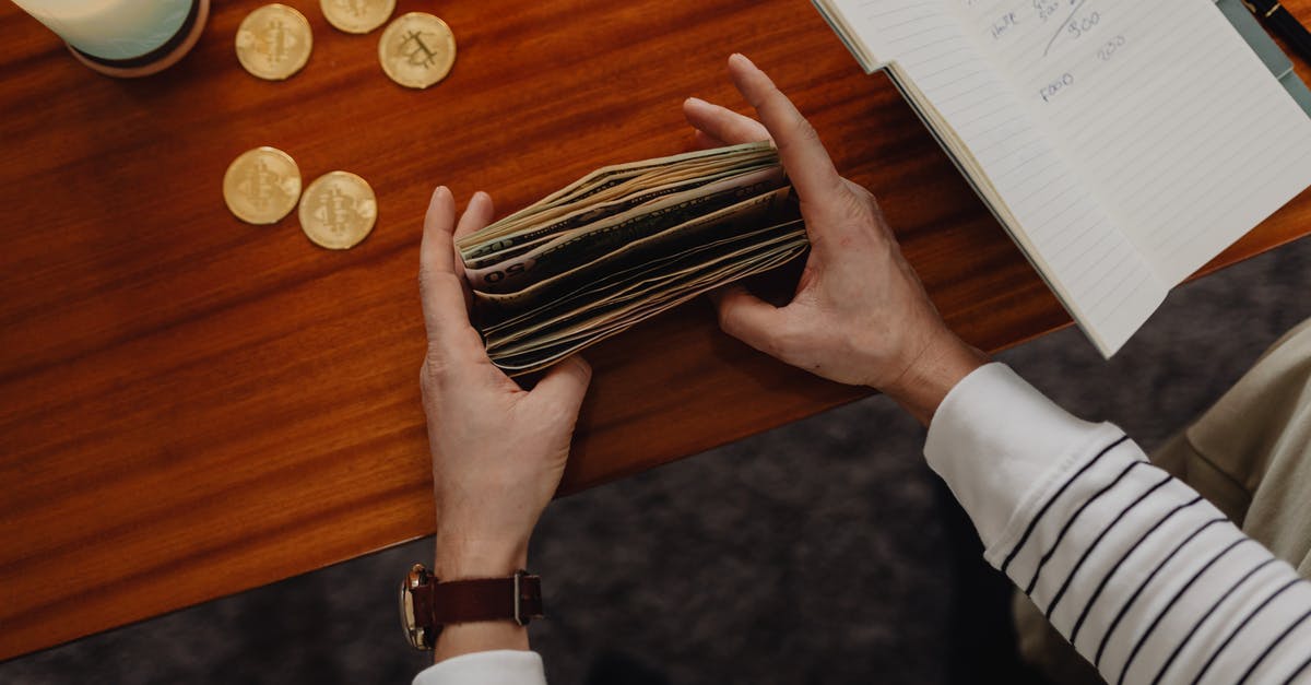 How useful are bitcoins when it comes to traveling? - Person Counting Bills and Bitcoins on Table How useful are bitcoins when it comes to traveling? - Person Counting Bills and Bitcoins on Table