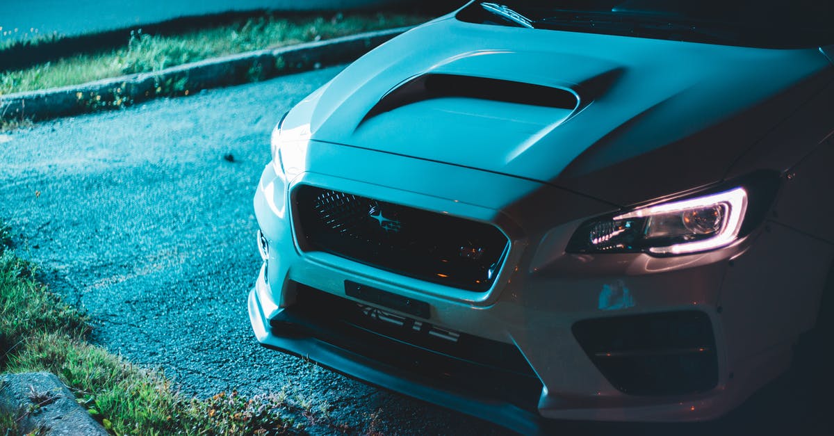 How well does Indonesian public transport run around around the New Year? - Luxury contemporary automobile with bright indicators parked on asphalt near fresh green grass