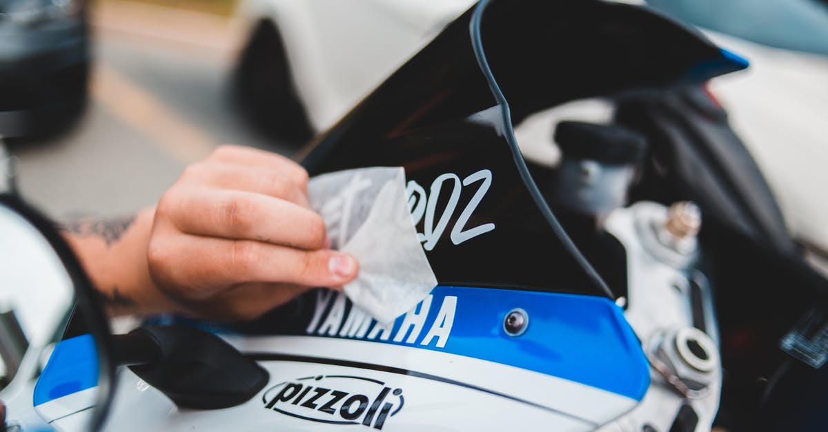 How well is Russias ban on driving a dirty car enforced? - Faceless person cleaning windshield of motorcycle How well is Russias ban on driving a dirty car enforced? - Faceless person cleaning windshield of motorcycle