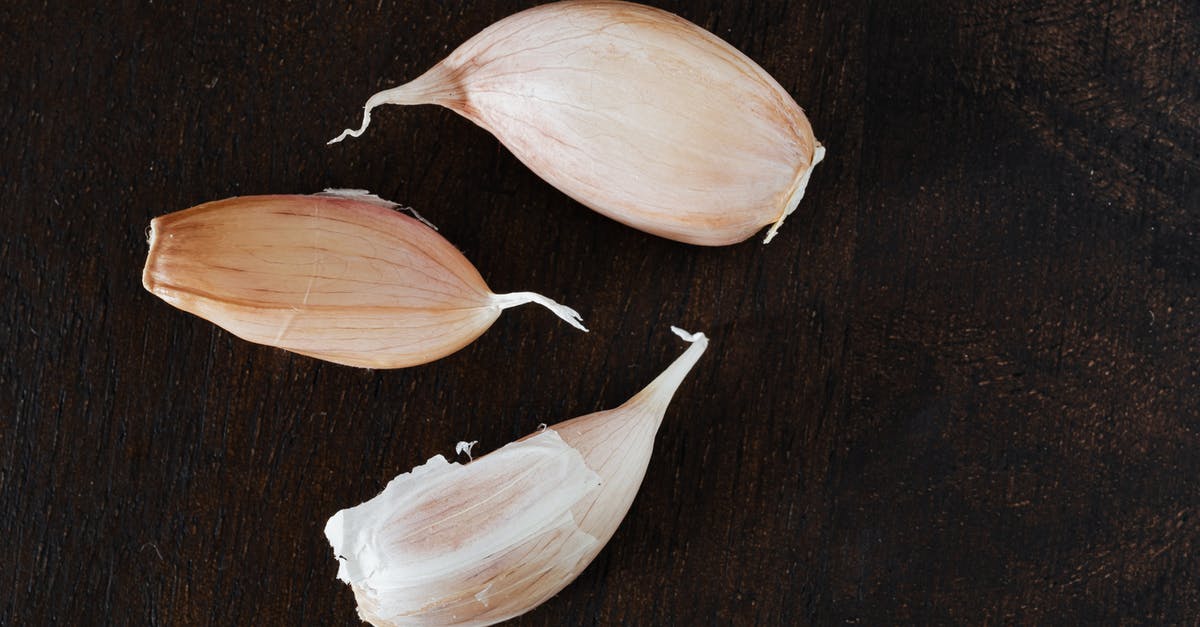 I've arrived in Paris without ID, nobody checked my passport through whole process [duplicate] - Top view of several cloves of ripe garlic in peel placed on wooden desk during cooking process at home