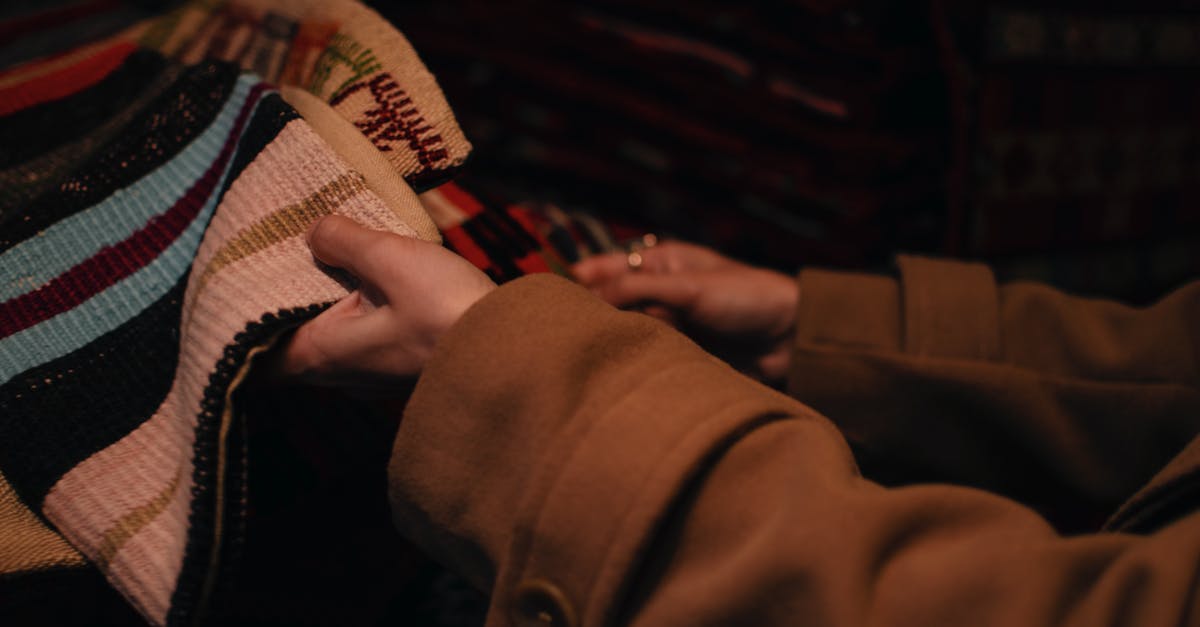 I've heard there are only two back-end solutions for airfare search. Does this mean I only need to search on two different sites? - Woman touching various knitted fabric in market