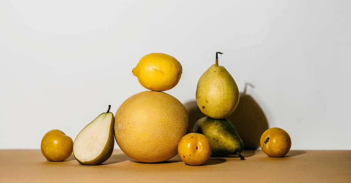 I-94: a half an hour overstay - A Group of Yellow Fruits and Green Pear on Brown Surface I-94: a half an hour overstay - A Group of Yellow Fruits and Green Pear on Brown Surface