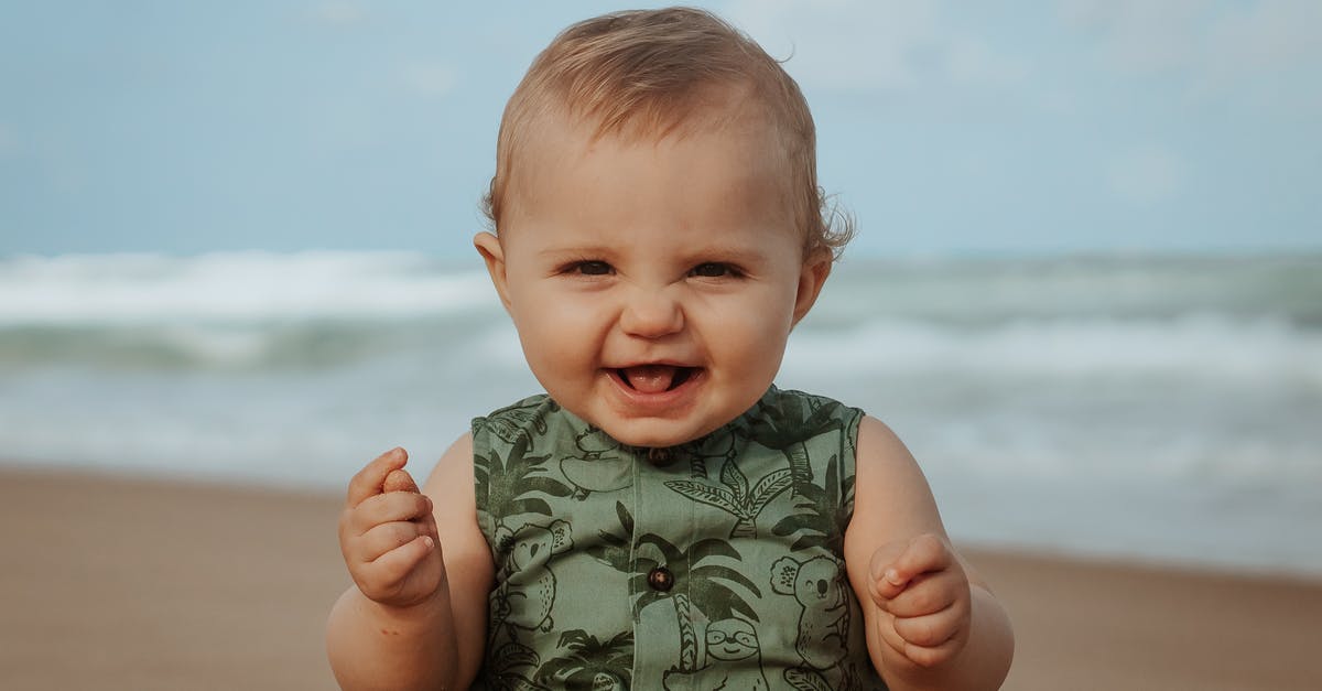 I am 17 looking to travel within florida, what kind of places can I stay as an unaccompanied minor? [closed] - Cheerful baby on sandy sea shore in stormy weather