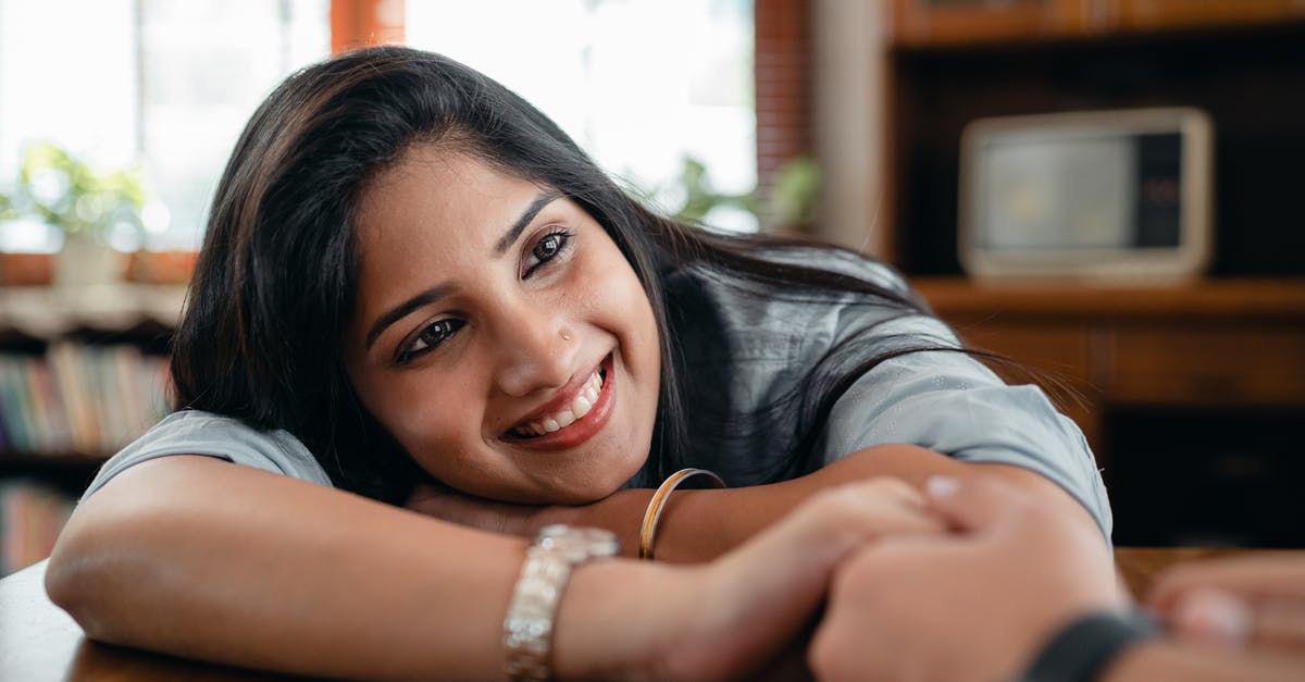 I am an Indian and currently holding a 1 year Dutch Living Permit. Can I enter the UK? - Cheerful Indian female in casual wear and wristband holding hand of crop faceless male beloved in wristwatch while sitting at table in living room in flat I am an Indian and currently holding a 1 year Dutch Living Permit. Can I enter the UK? - Cheerful Indian female in casual wear and wristband holding hand of crop faceless male beloved in wristwatch while sitting at table in living room in flat