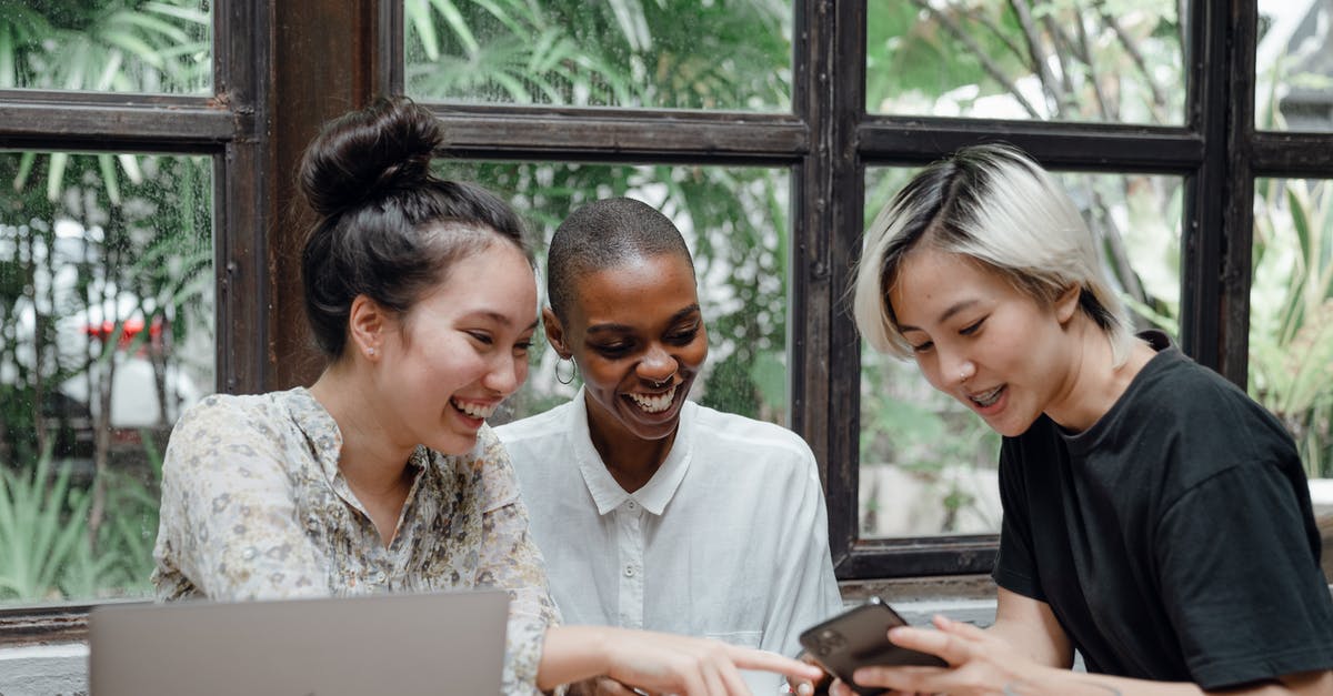 I am applying for a Tier 5 Youth Mobility visa, but have been refused a visa/overstayed in the Czech Republic/Schengen zone [duplicate] - Cheerful young diverse female friends laughing while watching funny video on smartphone during coffee break in cozy cafe