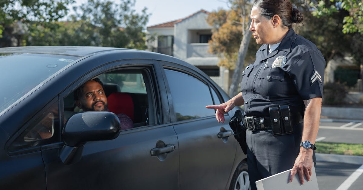 I bought an economy ticket and was issued first class ticket - Policewoman Talking to a Man Riding in a Car I bought an economy ticket and was issued first class ticket - Policewoman Talking to a Man Riding in a Car