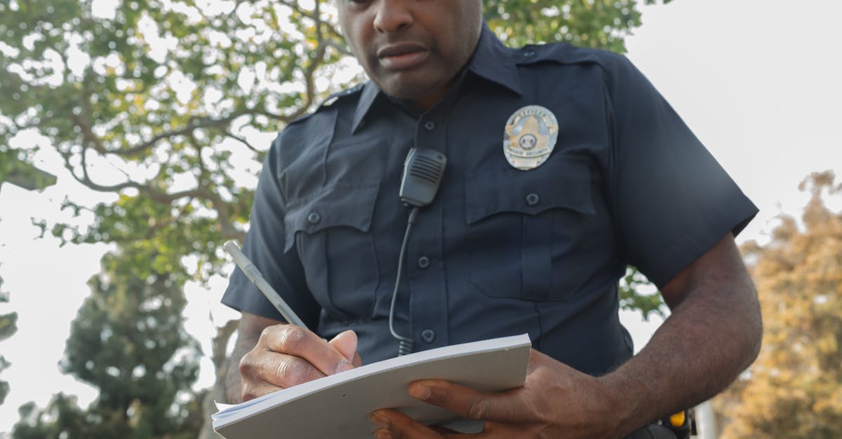 I bought an economy ticket and was issued first class ticket - Man in Black Police Uniform Writing on White Book I bought an economy ticket and was issued first class ticket - Man in Black Police Uniform Writing on White Book